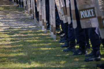 Fototapeta premium Riot police control the crowd practice and review on the grass field.