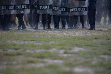 Fototapeta premium Riot police control the crowd practice and review on the grass field.