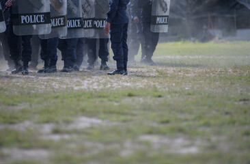 Fototapeta premium Riot police control the crowd practice and review on the grass field.