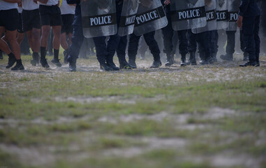 Fototapeta premium Riot police control the crowd practice and review on the grass field.
