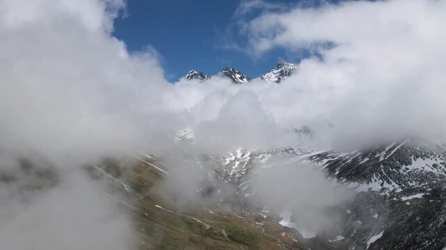 Snowy, cloudy mountains formed by steep cliffs. Peaks that are hard to reach.