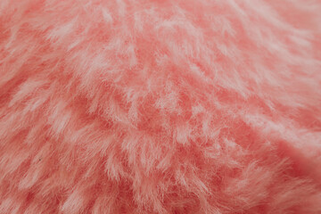 Soft pink plush fabric background with long fuzzy fibers, macro shot of delicate textile surface for romantic design or beauty backdrop © moryachka