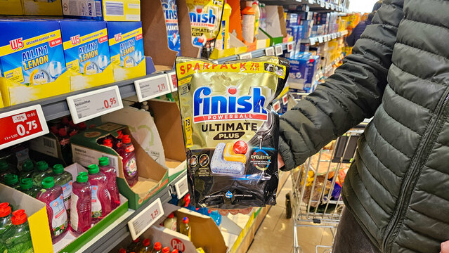 Person holding finish powerball ultimate plus dishwashing pods in supermarket