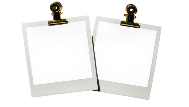 Two blank instant photo prints held by gold binder clips, isolated on transparent background