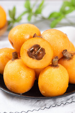 ripe loquat fruit on wooden table.