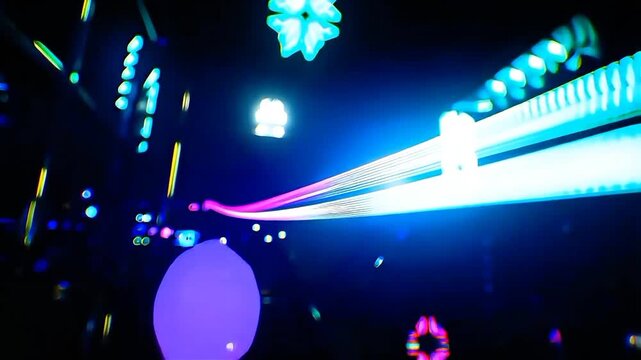 Abstract neon light trails on a rollercoaster track in a dark amusement park ride background