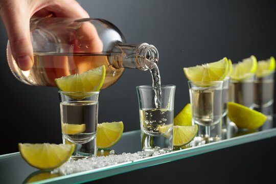 Tequila shots with salt and lime slices.
