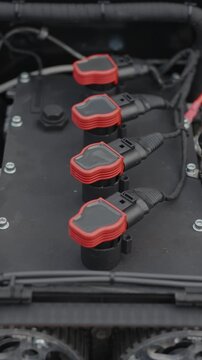 Cinematic close-up of high performance red ignition coils on engine