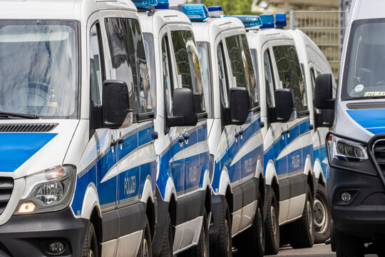 Police vehicles, squad buses, and motorcycles during a large-scale law enforcement operation.