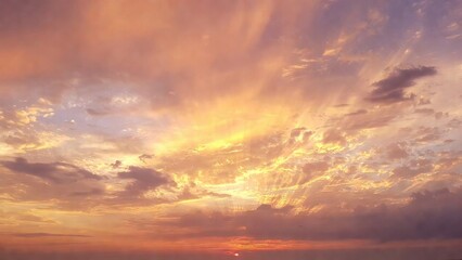 Fototapeta premium Dramatic sunrise over ocean with golden clouds and soft light landscape scenery