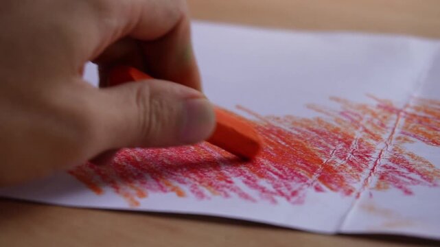 hand coloring paper with crayon