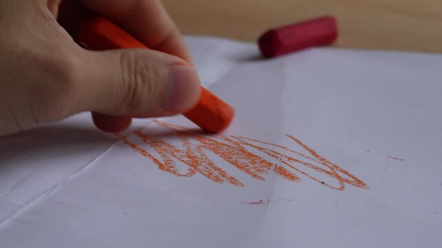 hand coloring paper with crayon