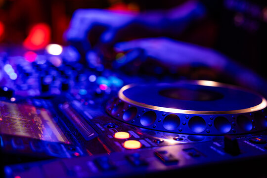 Professional dj mixer controller with lights at nightclub party close up