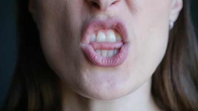 Close up angry woman mouth screaming, shouting with fury, showing her teeth and expressing intense aggression and frustration. Emotional portrait person in state of rage. Aggressively woman screaming
