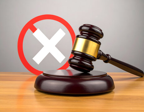 Gavel and Red Cross Symbol Representing Legal Prohibition or Rejection.