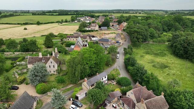 Aerial Drone Flight Over Winding Country Lane and Stone Cottages in Twywell Village