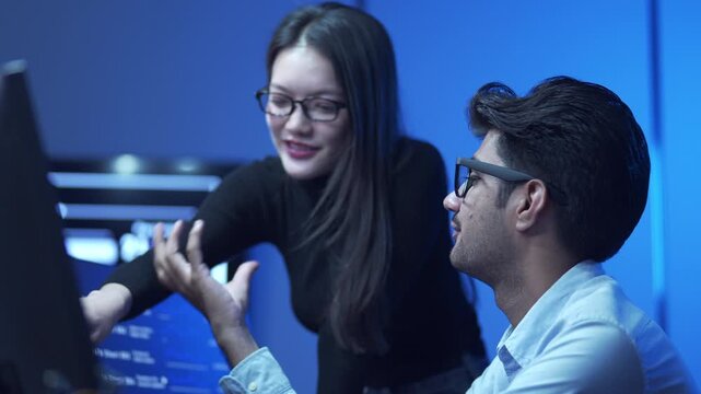 Close Up Of two Software developers working together on a coding project in a modern office.