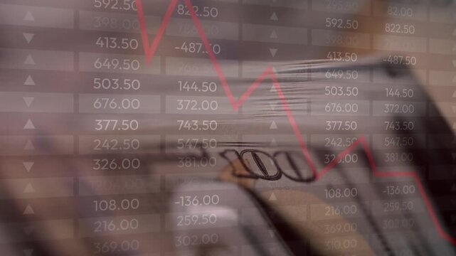 Close-up of US currency with an overlay of a declining red line graph and negative financial data sheet numbers
