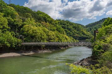Fototapeta premium Scenic suspension bridge and river landscape in Uji Kyoto