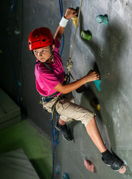 Boy Climbing Indoor Rock Wall.