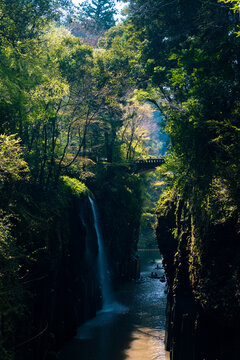 Manai Waterfall and tourists boating in Takachiho Gorge