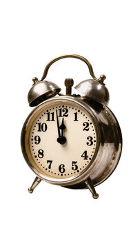 Isolated old-fashioned metallic alarm clock displaying almost midnight time on a white face
