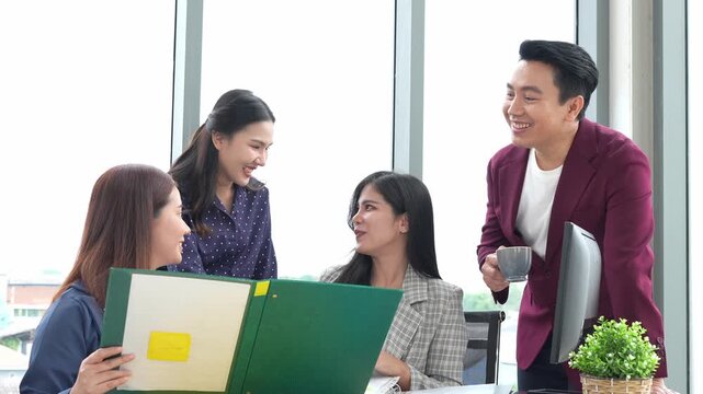 Asian entrepreneur group collaborates in office, fostering teamwork and cooperation to achieve their startup objectives. Their positive partnership drives success, creating a happy and successful job