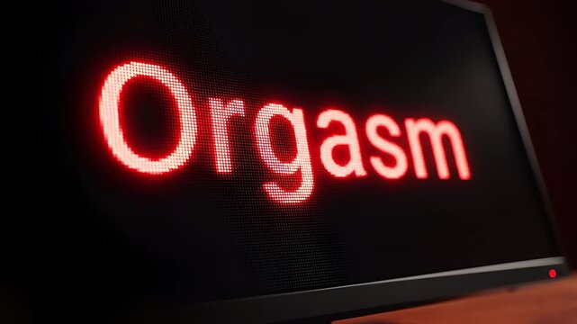 Computer Screen Displays the Word Orgasm in Red Neon Light.
