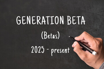 Fototapeta premium Generation Beta written on blackboard with hand, Betas born 2025 to present, generational demographics and social research concept