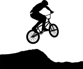 Fototapeta premium Silhouette of a BMX rider performing an aerial stunt jump.