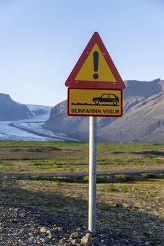 Warning for gravel road, mountains behind, ring road, Iceland