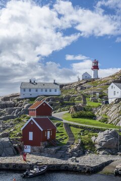 Houses and red and white Lindesnes lighthouse, Lindesnes, Norway