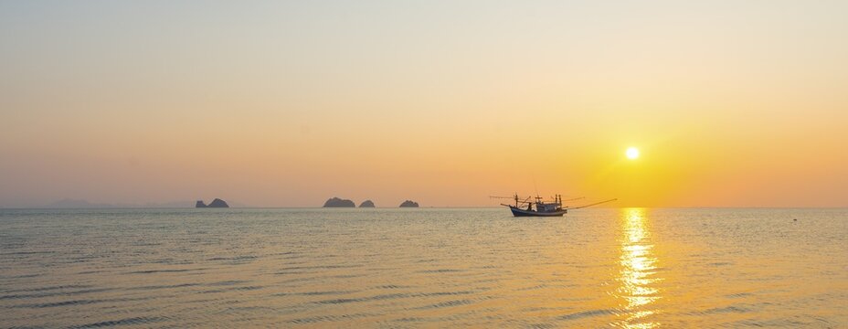 Boat in the sea at sunset in front of small islands, Koh Samui, Gulf of Thailand, Thailand