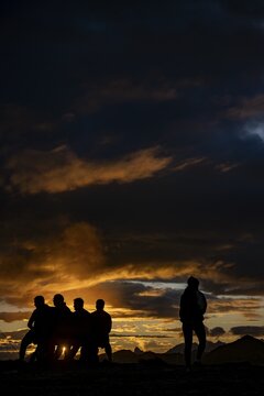 People marvelling at Montafon mountains with dramatic cloudy sky at sunset, Tschagguns, R&auml;tikon, Montafon, Vorarlberg, Austria