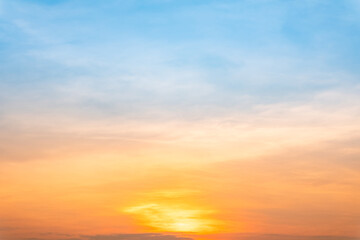 Fototapeta premium Sky sunset,Beautiful sunrise sky with vibrant gradient orange and gold colors and soft blue, Clear atmosphere with wispy clouds. Peaceful, perfect for background and copy space, High resolution images