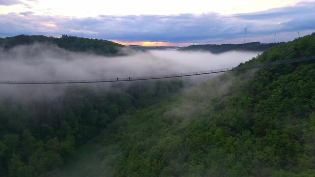 Explore the foggy hills and the Geierlay Bridge over Mosel Germany at sunset
