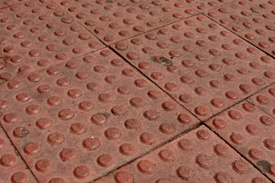 Red tactile paving with truncated domes providing accessibility