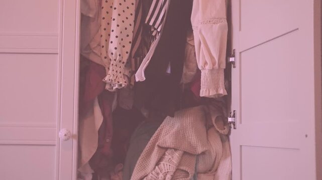 overcrowded wardrobe packed with clothes hangers, excess garments limited space, messy storage, decluttering, overconsumption lifestyle hoarding behavior accumulation, organization mental overload