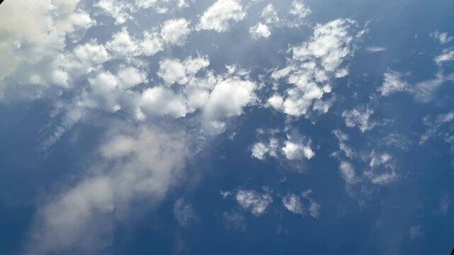 Beautiful blue sky with scattered white clouds and bright sunlight, ideal for nature or transitions background