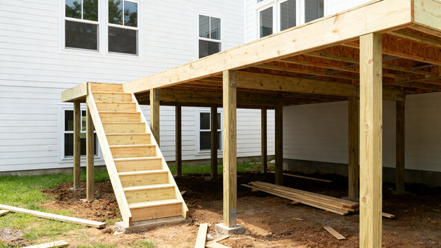 Construction of a New Wooden Deck with Stairs Attached to a Residential House