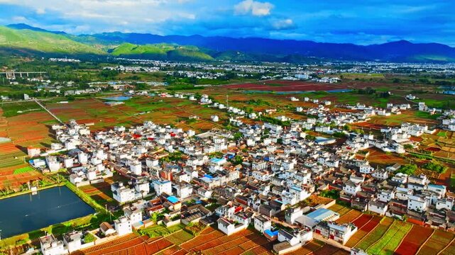 Aerial View of Rural Village, Farmland and Mountains
