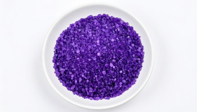 Vibrant purple potassium permanganate crystals piled in a white dish, showcasing intense chemical color