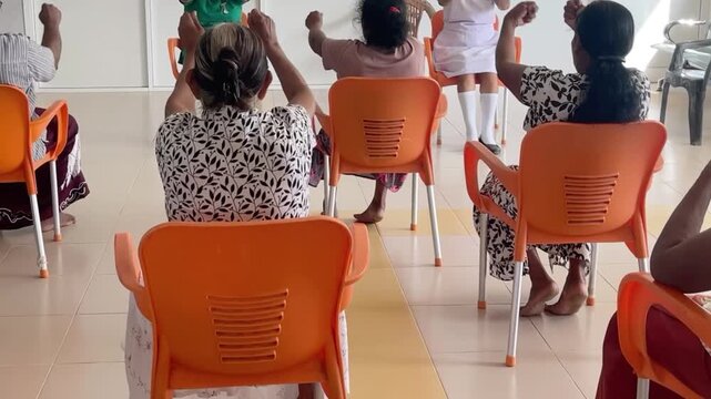 : Video of Asian older adults taking part in an indoor exercise session, showing active aging, community wellness, mobility, balance, and senior fitness.
