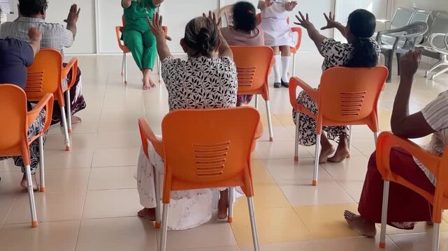 Close-up video of Asian older adults doing hand muscle exercise for grip strength, dexterity, rehabilitation, and physiotherapy, suitable for senior wellness and recovery content.