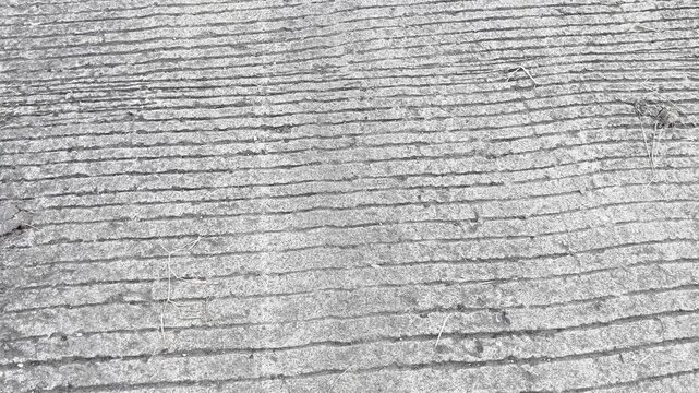 Close up of rough grooved concrete road surface texture