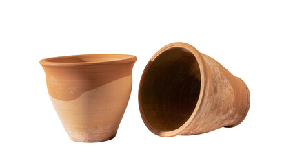 Isolated pair of traditional terracotta clay flower pots, one upright and one fallen, for gardening © Niamh