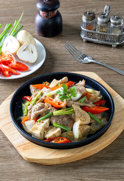 Hot plate of oyster sauce beef on a wooden table.