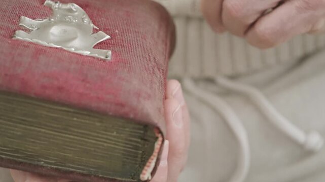 male hands leafing through pages of an old photo album, black and white photographs, evoking nostalgia and cherished memories past, reminiscing about family history and forgotten moments, genealogy