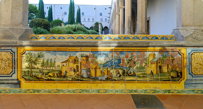 The famous Cloister of Santa Chiara with ornate ceramic tiled columns and benches in the historic center of Naples, Italy