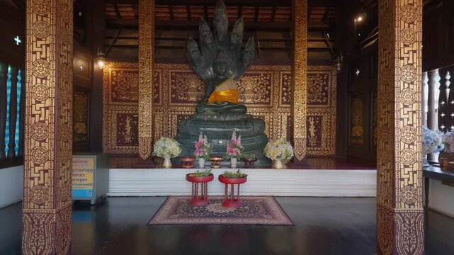 A Buddha image in the Naga-protected posture, made of jade, Lanna art, Mahayana art, Chiang Mai, Thailand.